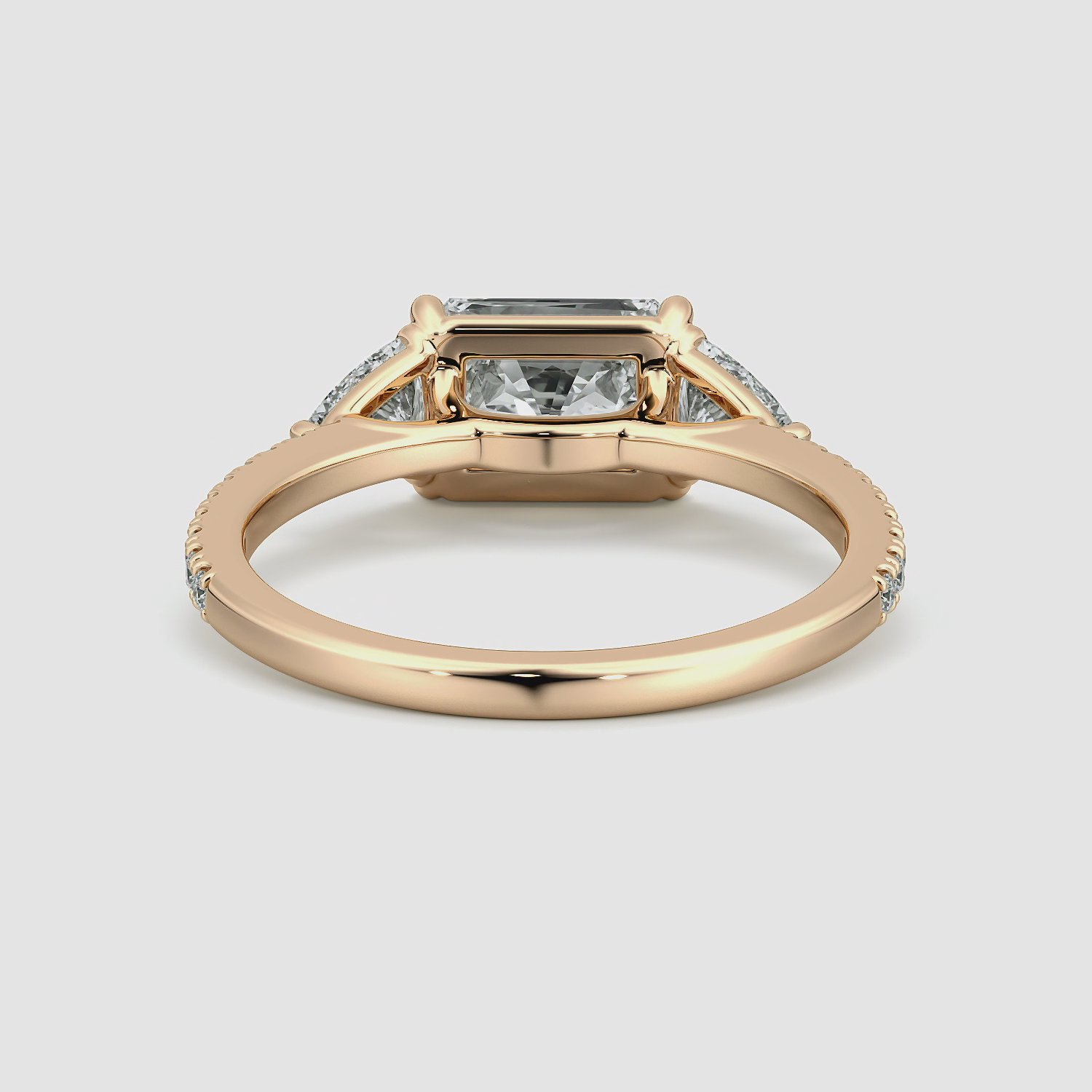 The Three Stone | Radiant | 14k | Rose Gold | bandAccent: Pavé | diamondOrientation: horizontal | sideStoneCarat: 0.25ct | sideStoneShape: Trillion | caratWeight: other