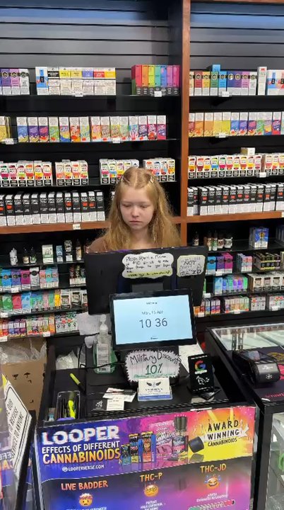 Smoke Heaven - Friendly staff member at the checkout counter of Smoke Heaven of Tomball featuring premium ciars, Disposable Vapes, CBD Hemp and Kratom. - Vape Shops Near Me - Tomball, Texas