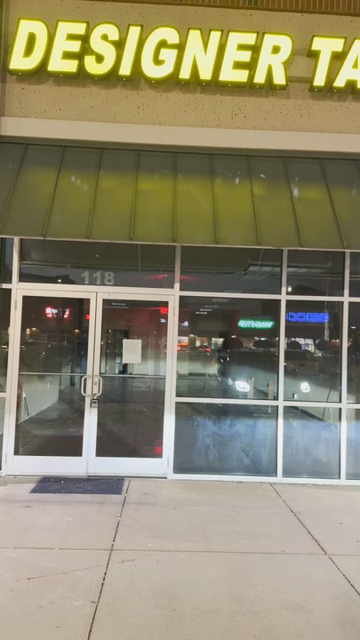 Designer Tan - Empty Building with master lock. - Tanning Beds Near Me - McDonough, Georgia