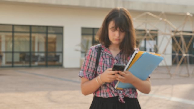 Girl texting on the school campus