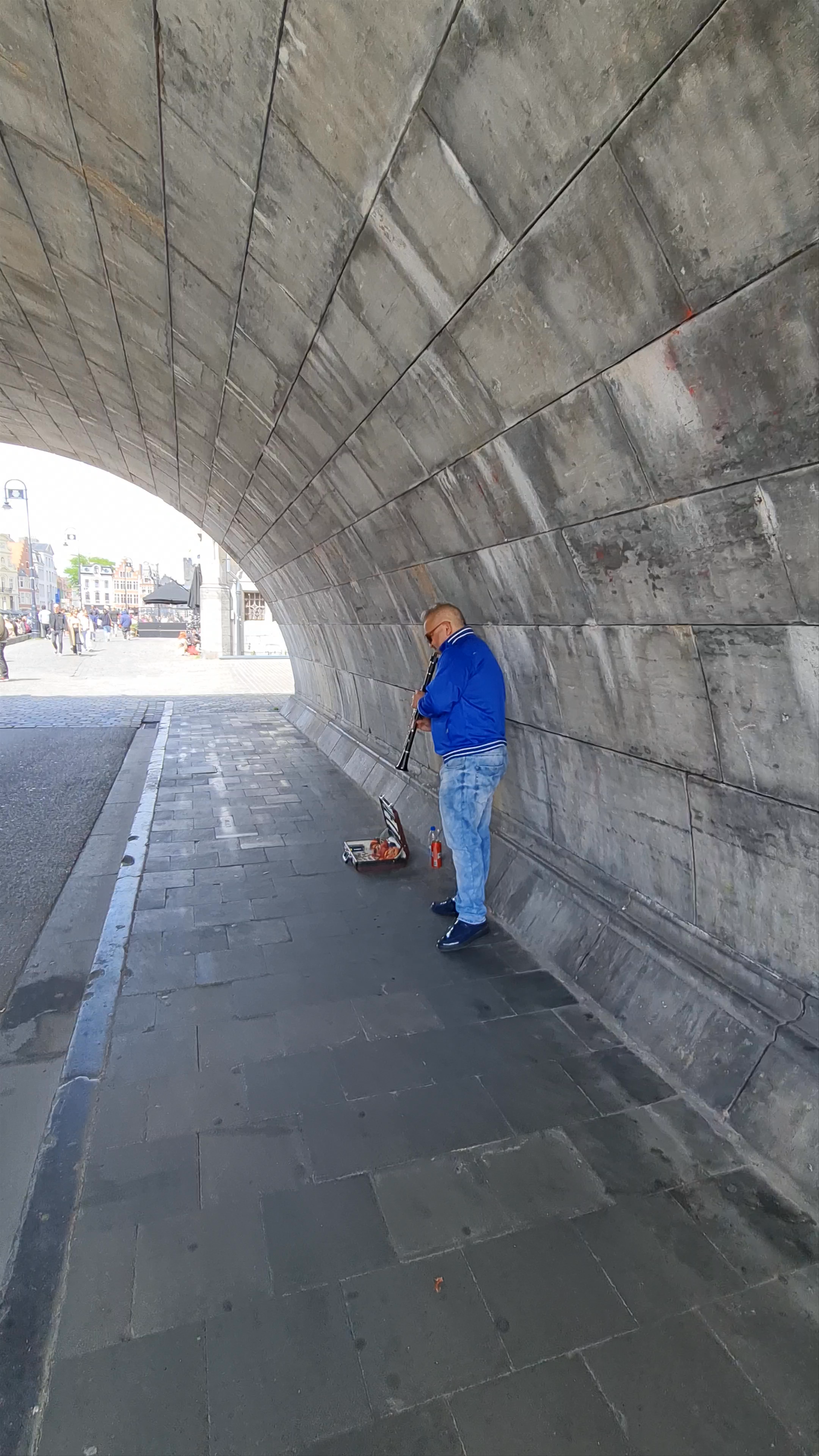 Busking Musician under the Archway at Graslei, Ghent