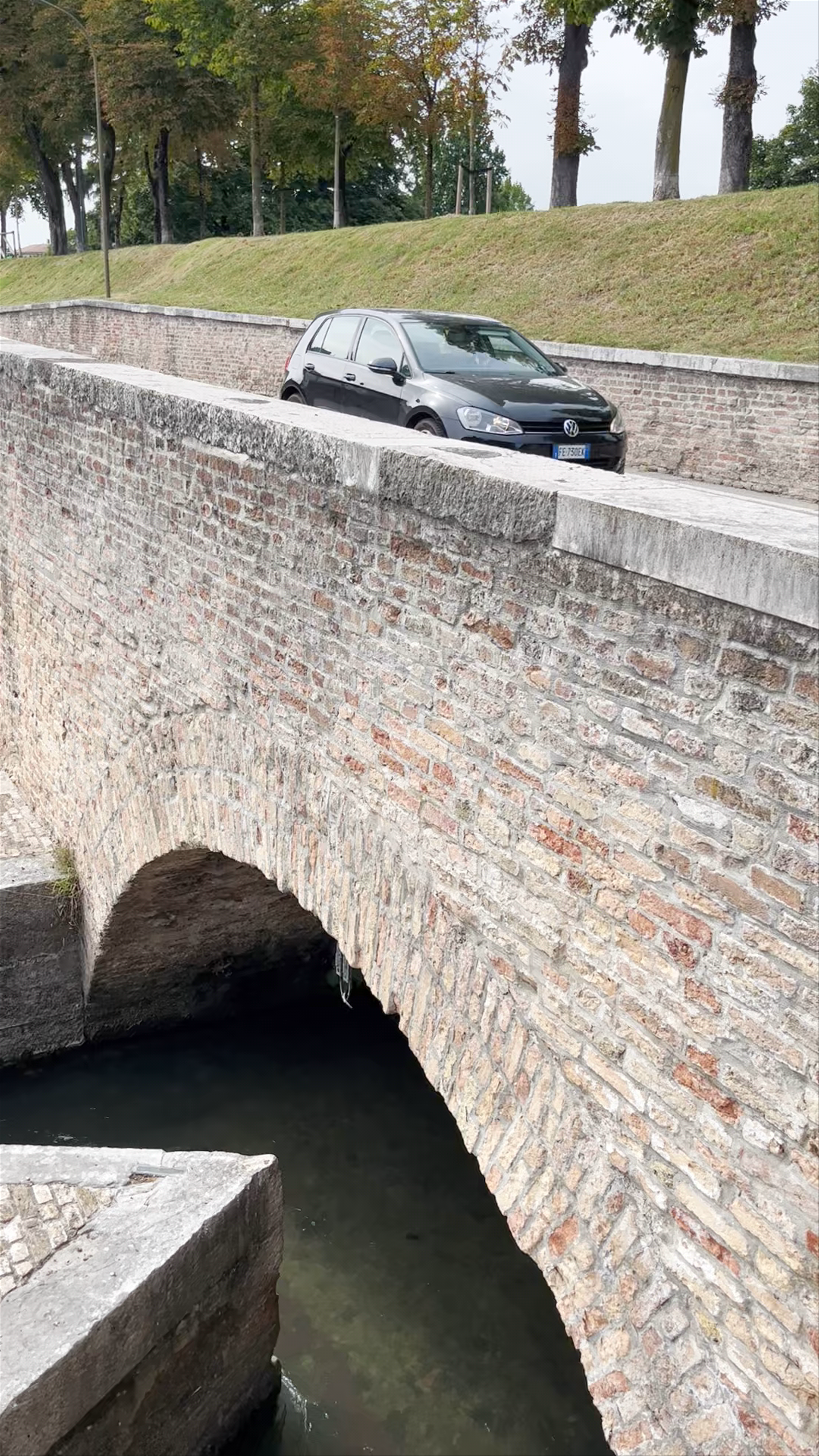 Historic Cycling Statue and Canal Views in Treviso, Italy