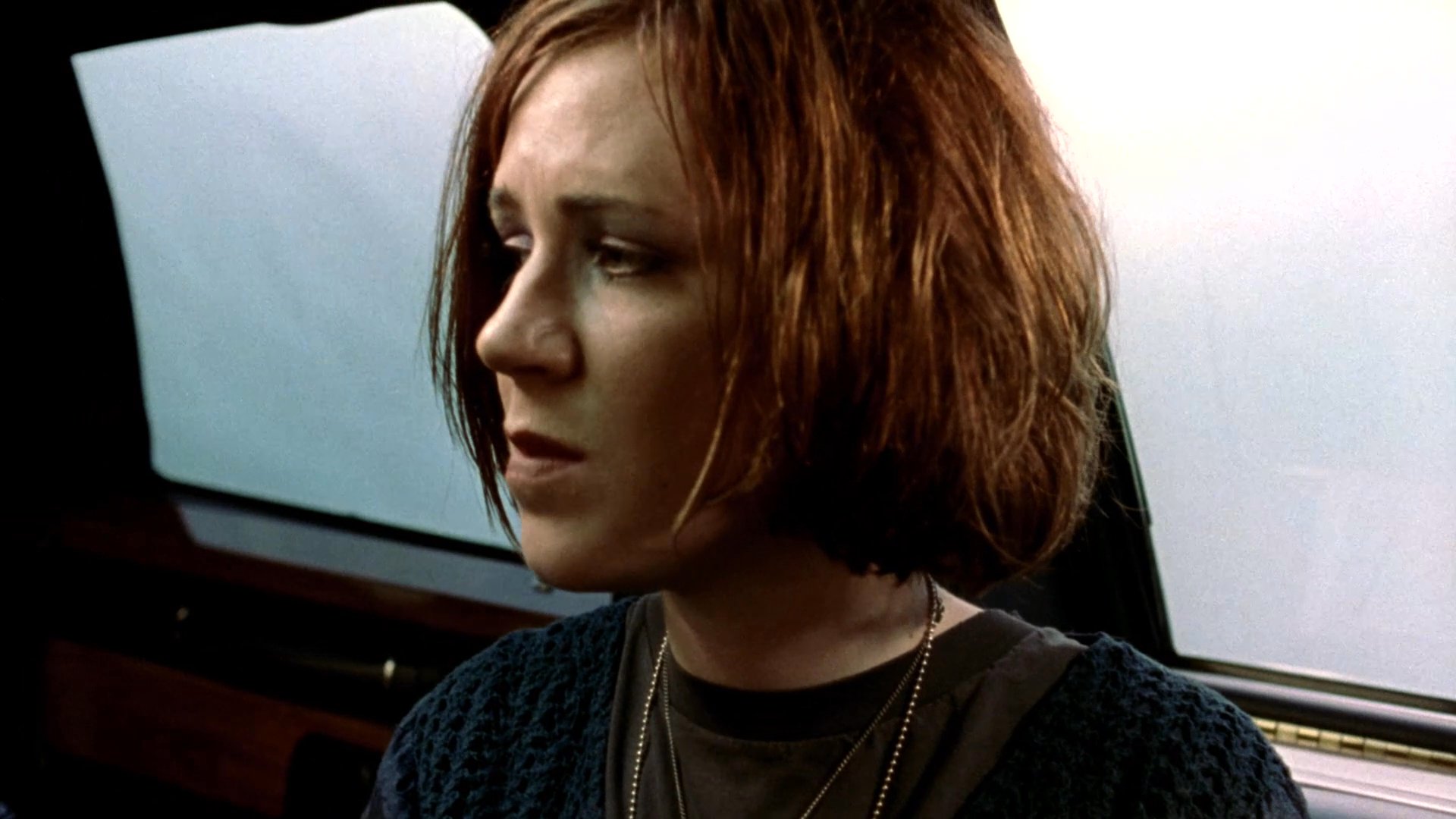 Three individuals engage in a serious and emotionally charged conversation while riding in the backseat of a limousine. They exchange views and react to one another during the transit.