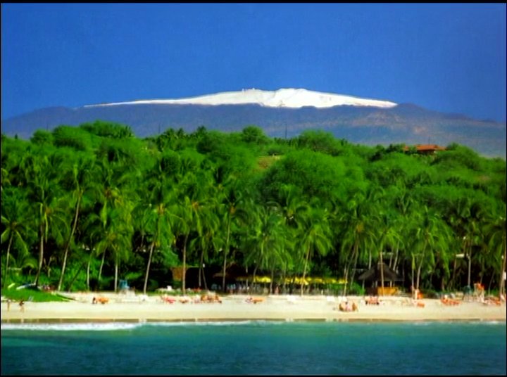 A woman shares a personal testimonial while alternating with scenic shots of a Hawaiian beach and the snow-capped Mauna Kea peak at sunset.