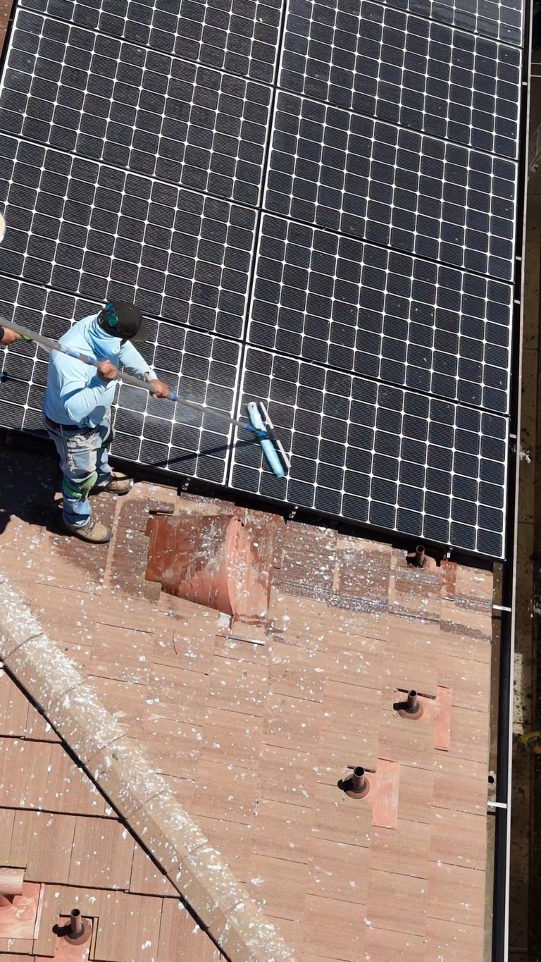 The Triple R crew cleaning solar panels.
