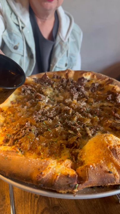 Babylon Social - April special, French Dip Pizza, pouring on the au jus - Pop-Up Restaurants Near Me - Babylon, New York