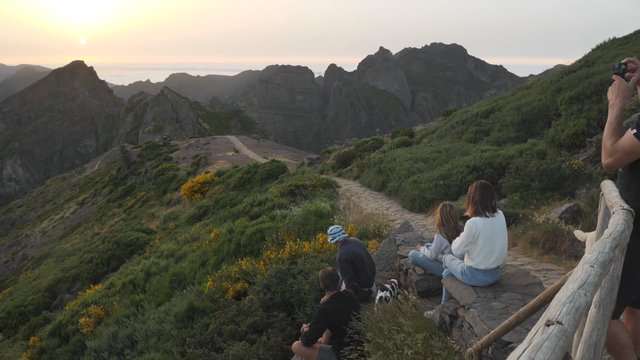 Friends watching the sunset on mountain top