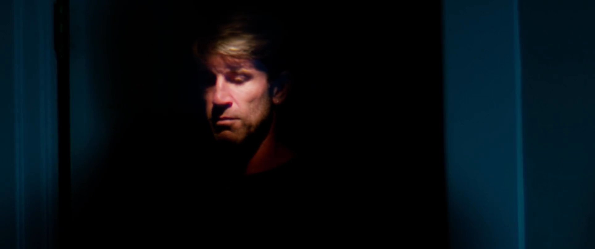 A man experiences a restless night in his bedroom, transitioning from outdoor memories to awake in the dark. He grapples with sleeplessness in a quiet, dimly lit environment.