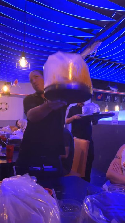 Ocean House - Our amazing server, Chris, showing us how to dig into the seafood boil! - Seafood Near Me - Clermont, Florida