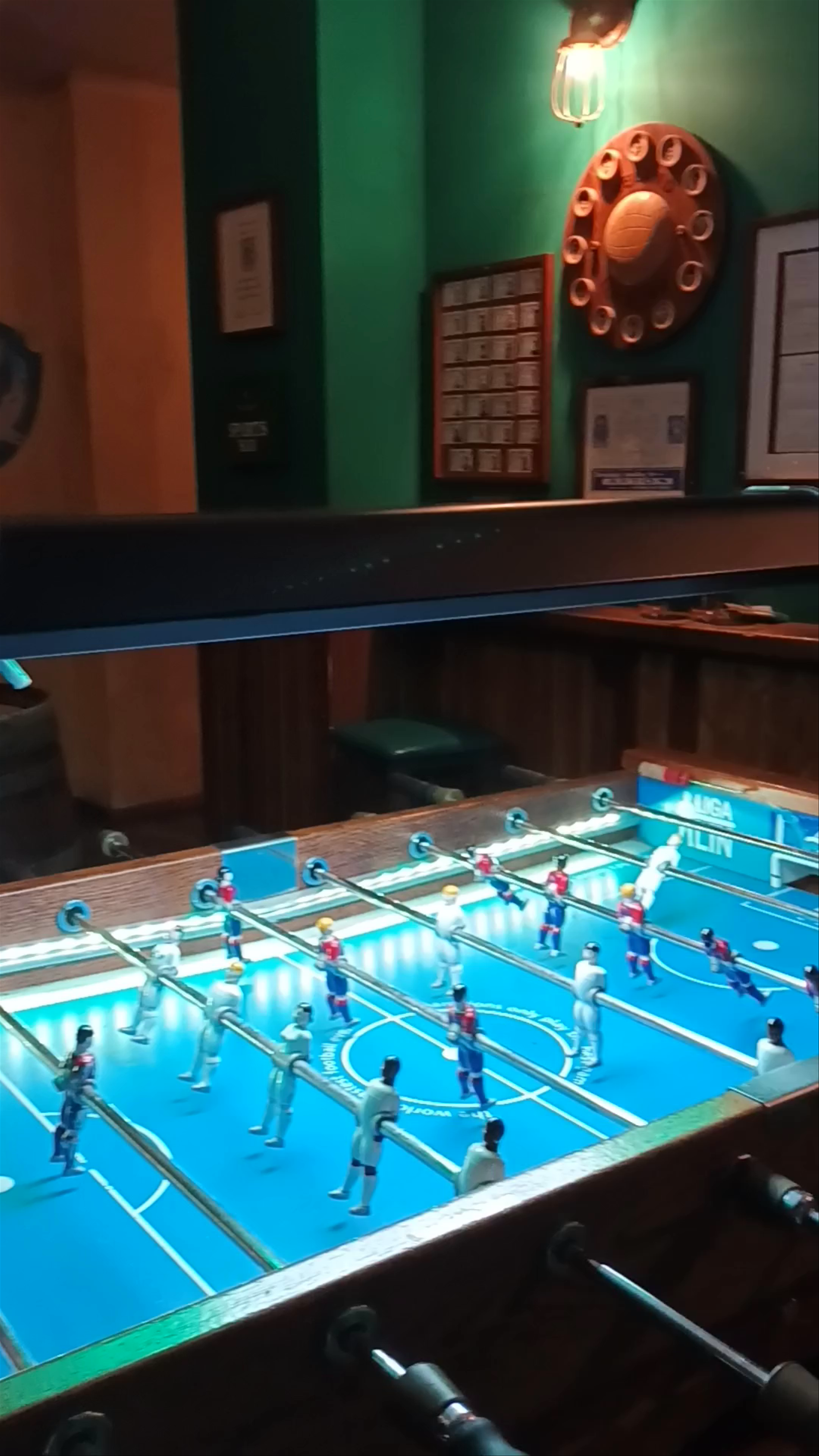 Lively Night at a Cozy Valencian Bar Featuring Foosball Fun