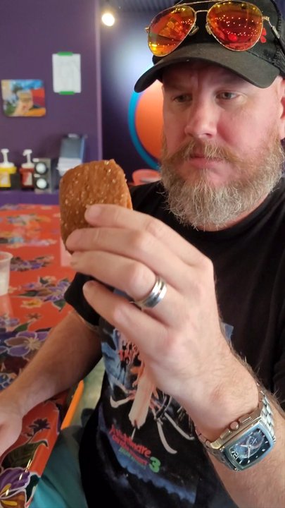 QueenBurger - Biting into a Rose's strawberry creme brulee ice cream sandwich - Burgers Near Me - Durham, North Carolina