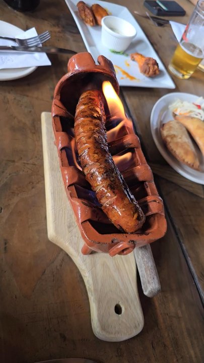 Raizes - Flaming Chourico. Homemade spicy sausage comes to the table on fire. Mild spicy. Very tasty, and fun presentation - Portuguese Near Me - Brooklyn, New York