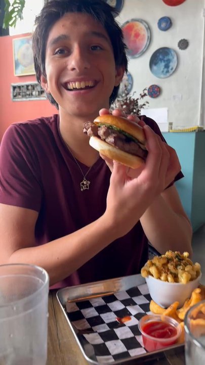 The Kosmos - First bite of the burger - Bars Near Me - Albuquerque, New Mexico