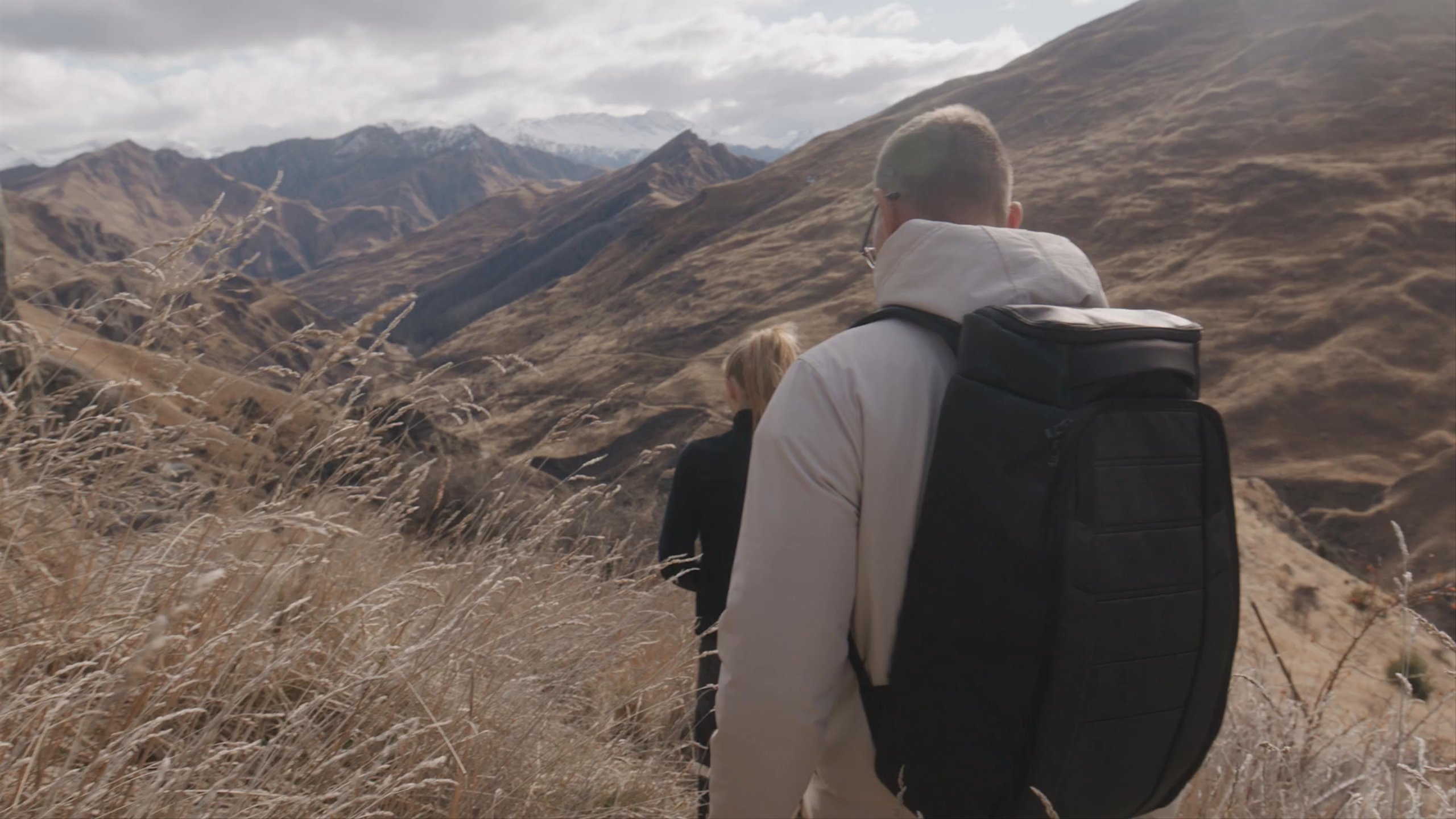 Man and woman hiking and climbing in the mountains.