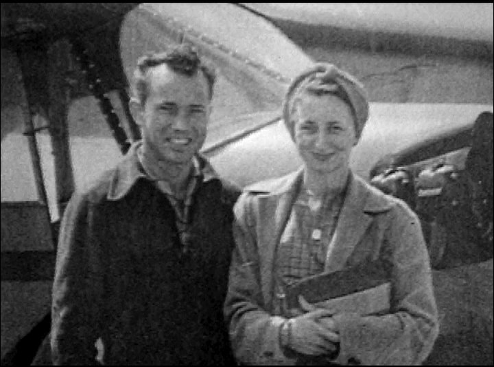 An elderly man shares personal memories, juxtaposed with vintage archival footage of camping trips and aviation history. The transition between contemporary interview segments and historical film highlights a reflective narrative on past experiences.