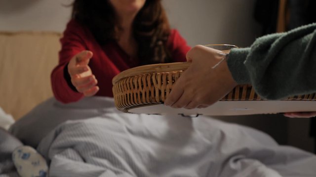Mom getting breakfast in bed from her daughter