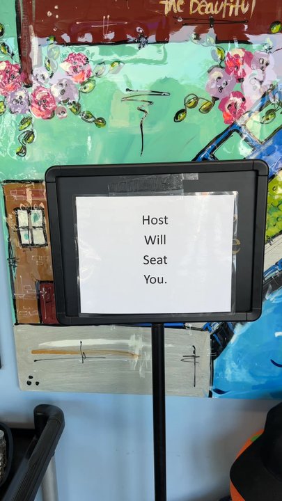Harbor View Cafe - The sign that states "host will seat you" - Breakfast & Brunch Near Me - Charlevoix, Michigan