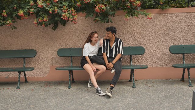 Couple relaxing on bench