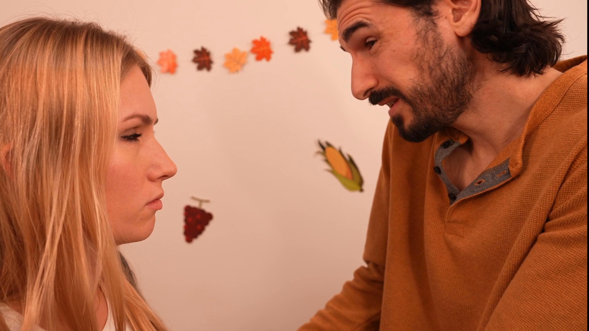 Individuals engage in a serious, emotionally charged conversation within a domestic setting. The interaction involves multiple participants alternating between intense discussion and reflective contemplation.
