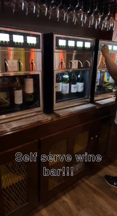 Della Viti - Their wall of wine machines each containing 4 bottles of various selections. You can do 2.75 oz, 5 oz, or 8 oz pours - Wine Bars Near Me - Ames, Iowa