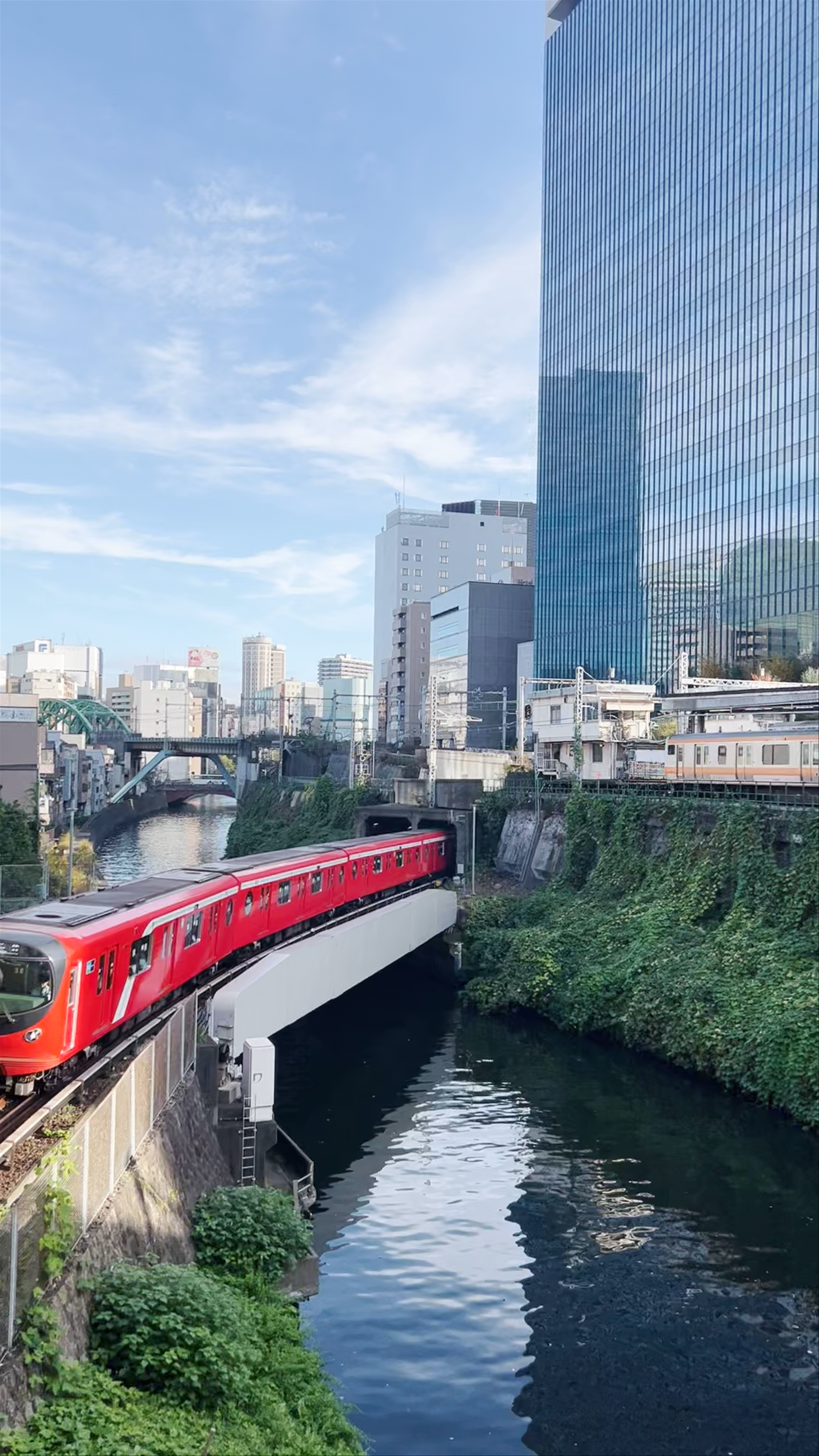 Red Train Crossing Surugadai in Heart of Tokyo