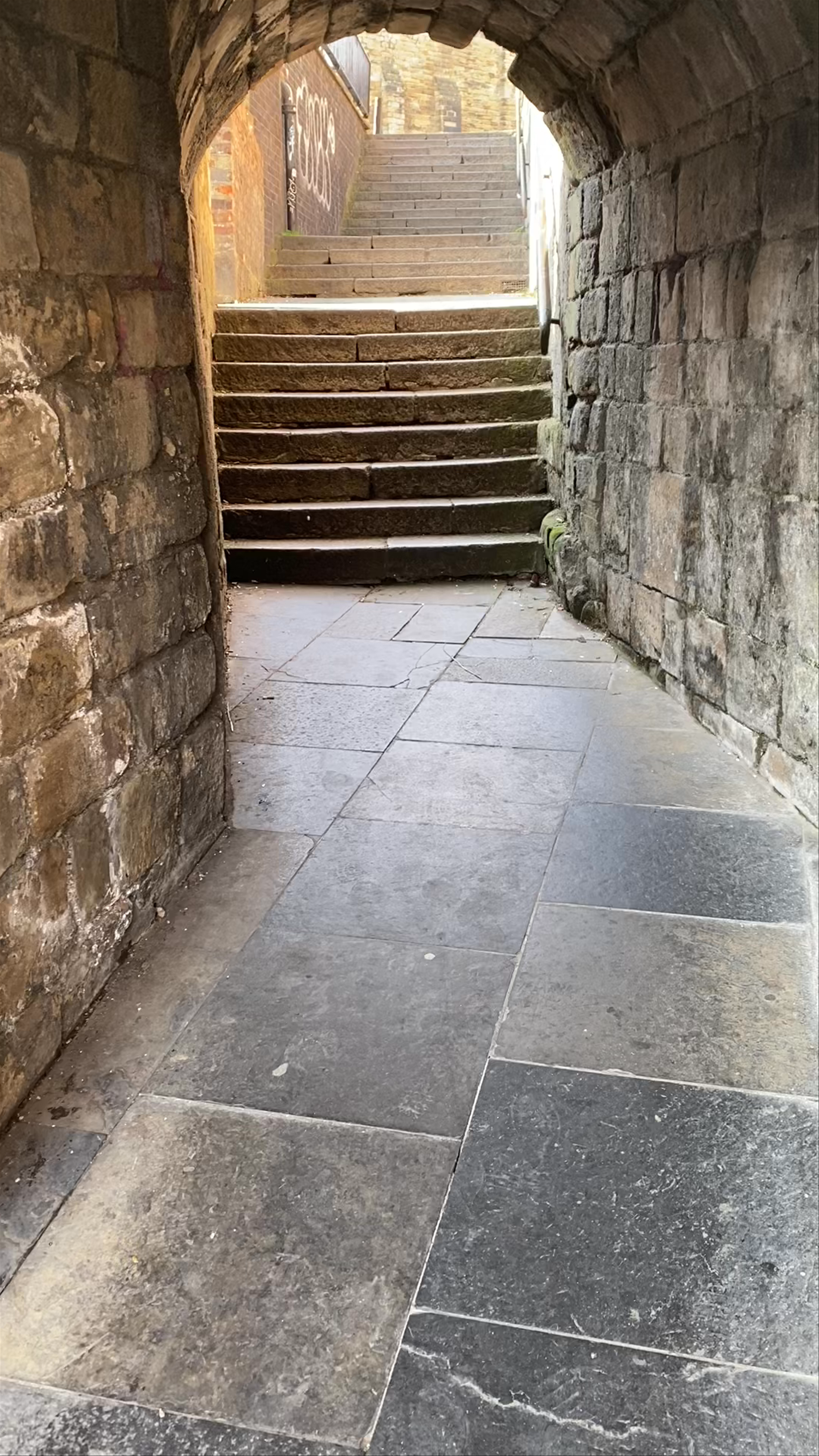 Historic Walk Through Newcastle Castle's Stone Archway and Steps