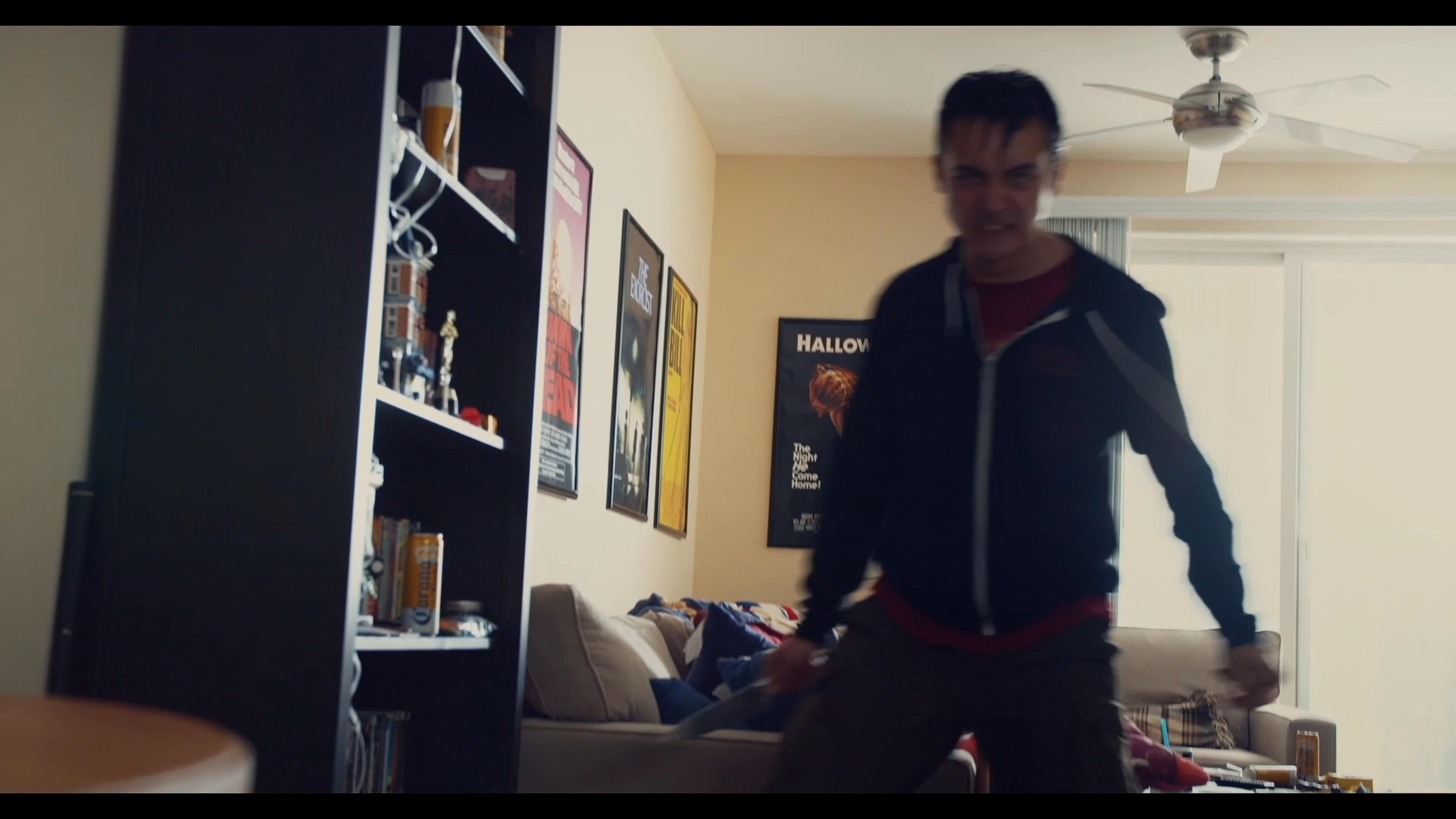 An individual defends his apartment from a knife-wielding intruder by engaging in a tense armed standoff and physical confrontation. The scene captures the high-stakes encounter as the defender attempts to neutralize the threat within the living space.