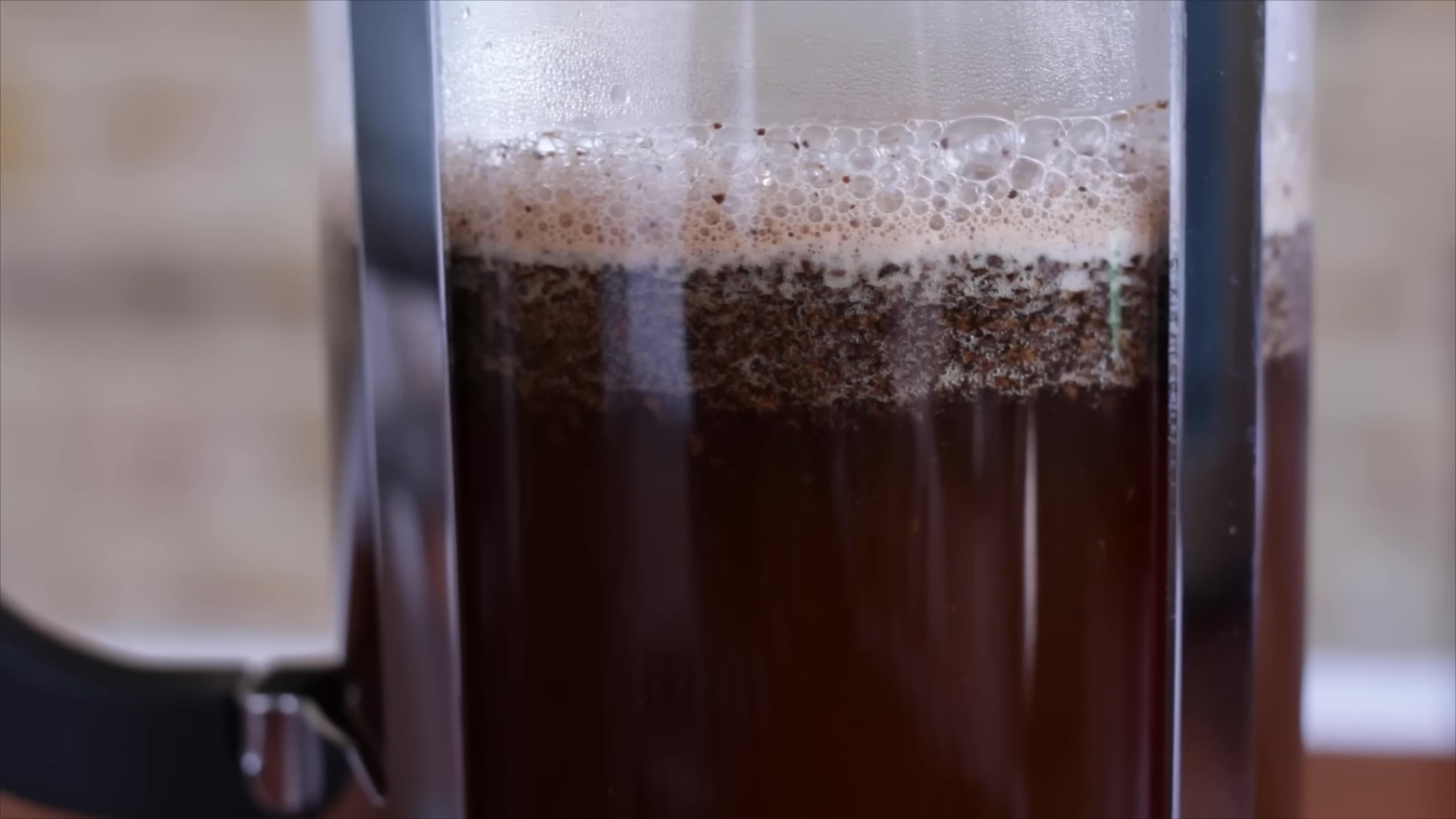 water poured into a french press full of coffee