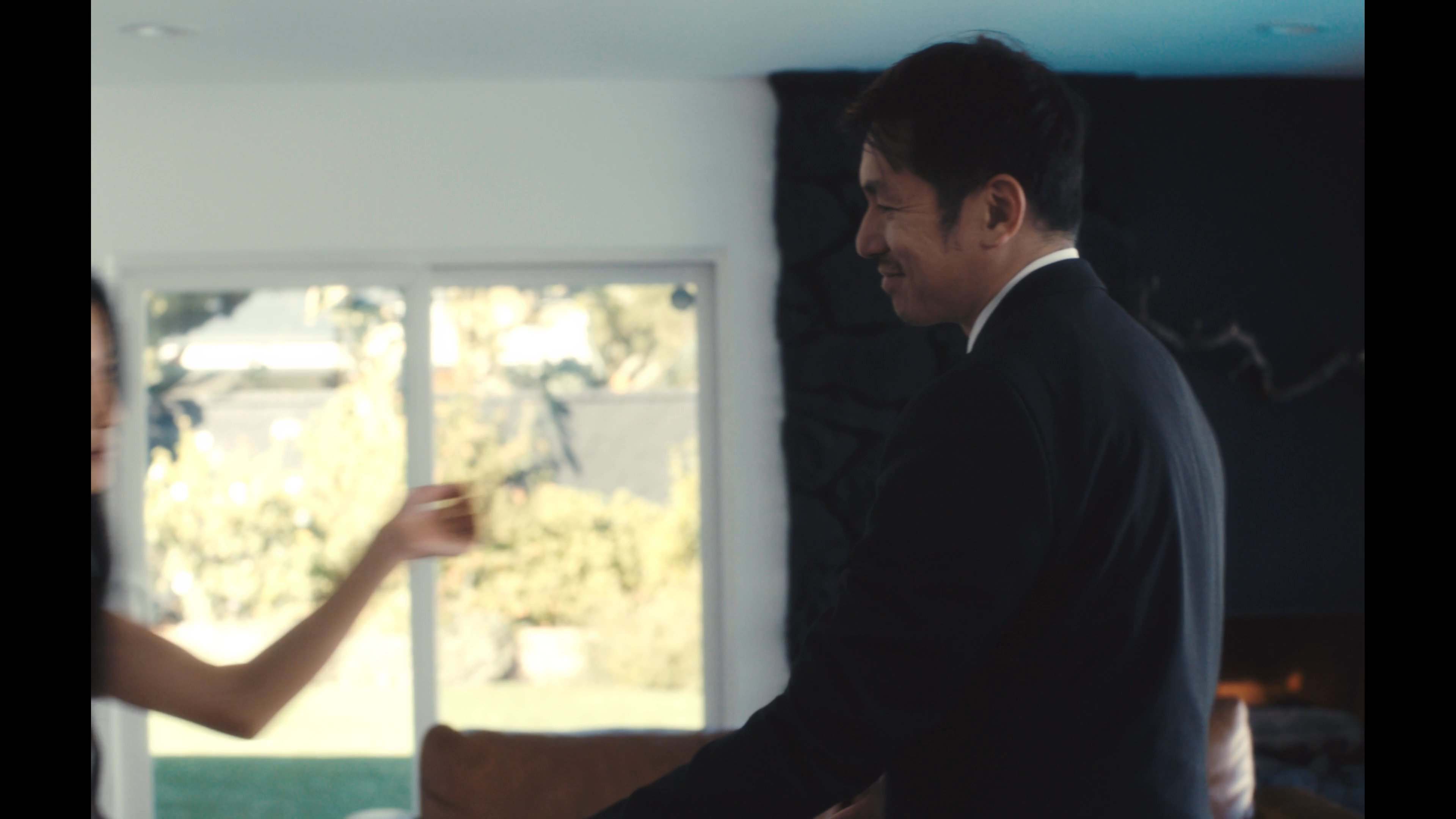 A man wearing a virtual reality headset interacts with a digital simulation of a woman in a modern living space. The experience transitions from a solitary technical session to an intimate, immersive moment of connection between the two figures.