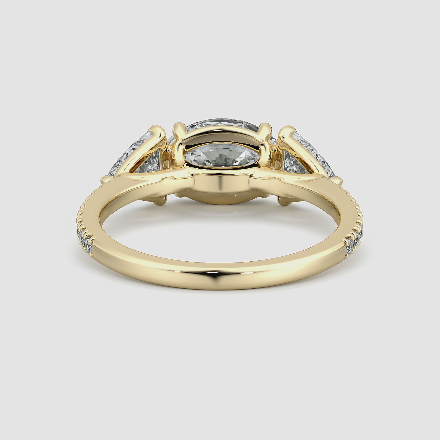 The Three Stone | Oval | 18k | Yellow Gold | bandAccent: Pavé | diamondOrientation: horizontal | sideStoneCarat: 0.50ct | sideStoneShape: Trillion | caratWeight: other