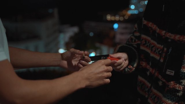 Man lighting a cigarette with his lighter