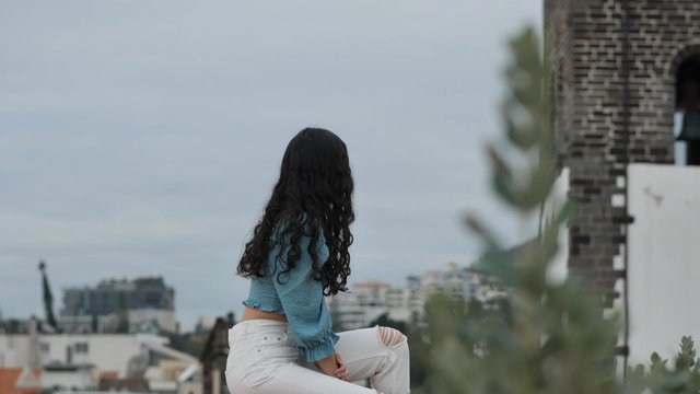 Girl posing on the edge of a terrace