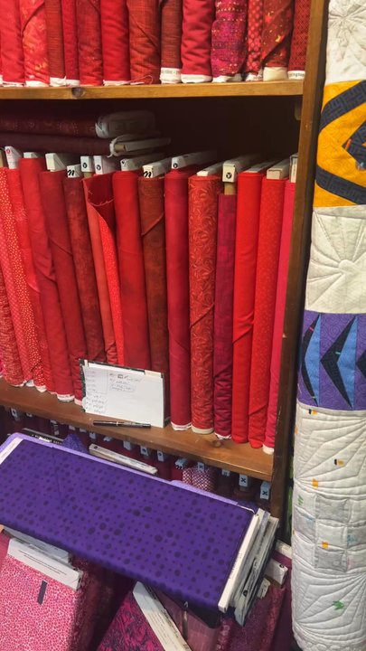 Stitches Quilt Shop - Having fabrics arranged by color value is a treat for the eyes! - Fabric Stores Near Me - Cincinnati, Ohio