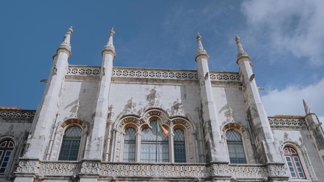 Jeronimos Monastery with a Portugal flag