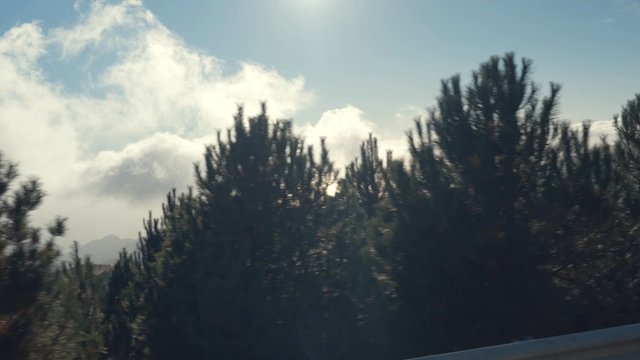 A breathtaking view of the horizon behind hills and trees