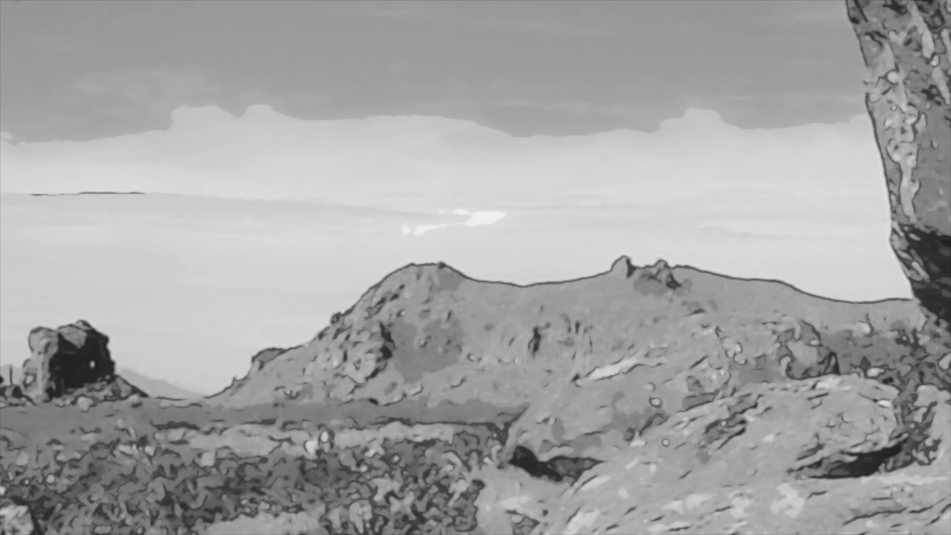 A man stands in a dimly lit room before the perspective shifts to a wide, cinematic view of a rugged, arid desert landscape featuring dramatic rock formations.