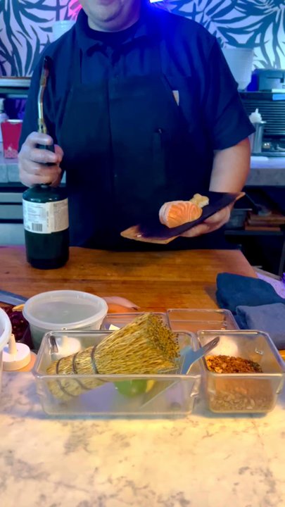 Across The Pond - Sushi chef searing salmon - Cocktail Bars Near Me - Phoenix, Arizona