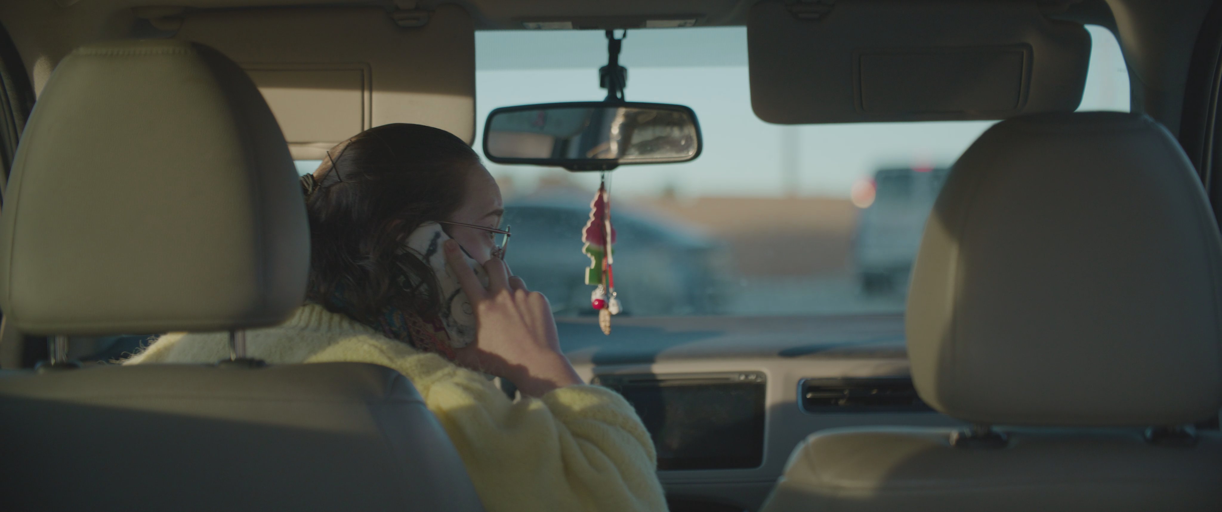 A woman retrieves a handgun from a drawer before transitioning to a tense conversation with a man inside a parked car.
