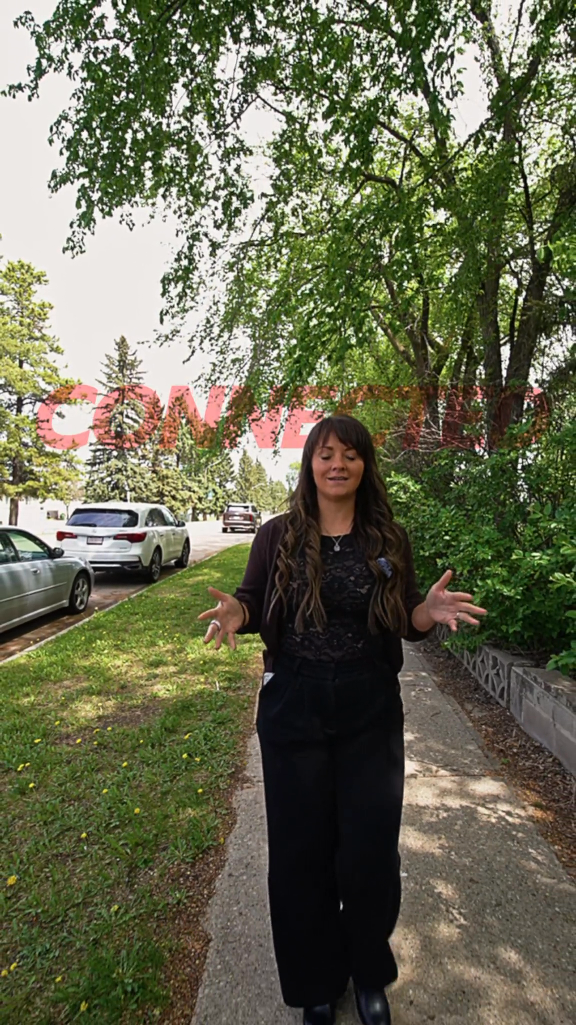 Vertical video poster showing a person walking along a tree-lined lane.