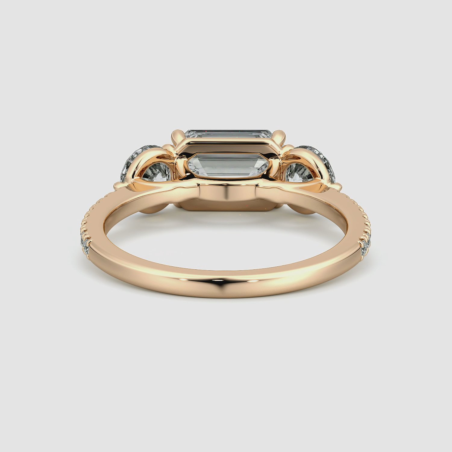 The Three Stone | Emerald | 14k | Rose Gold | bandAccent: Pavé | diamondOrientation: horizontal | sideStoneCarat: 0.50ct | sideStoneShape: Round Brilliant | caratWeight: other