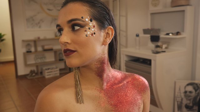 Putting glitter on a woman's neck