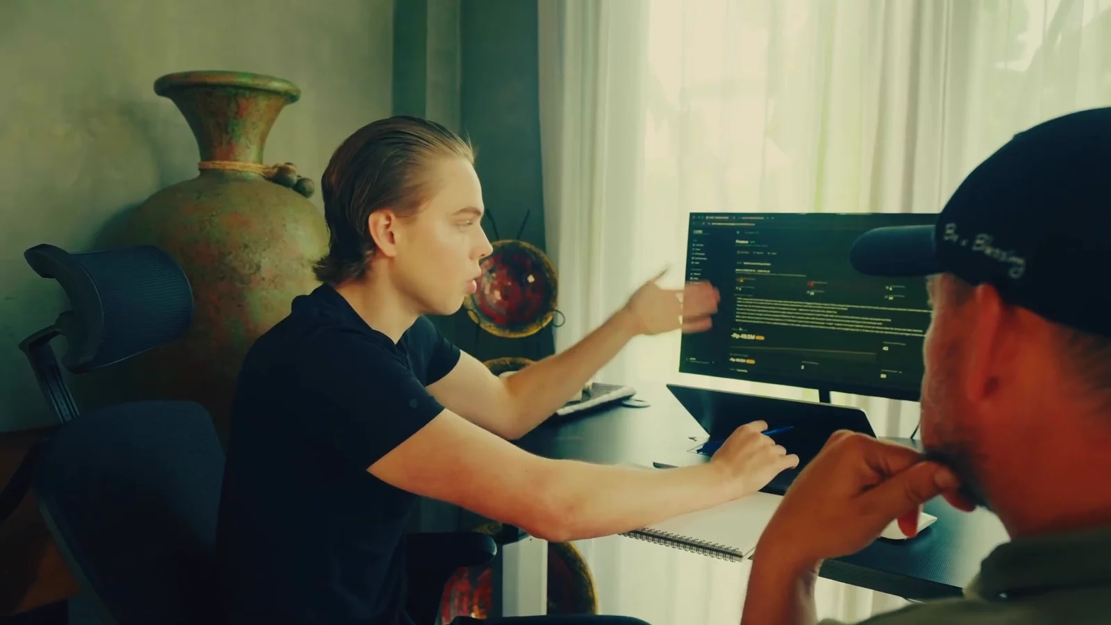 Chris White and Archie Nash at the monitor, reading the ad account together