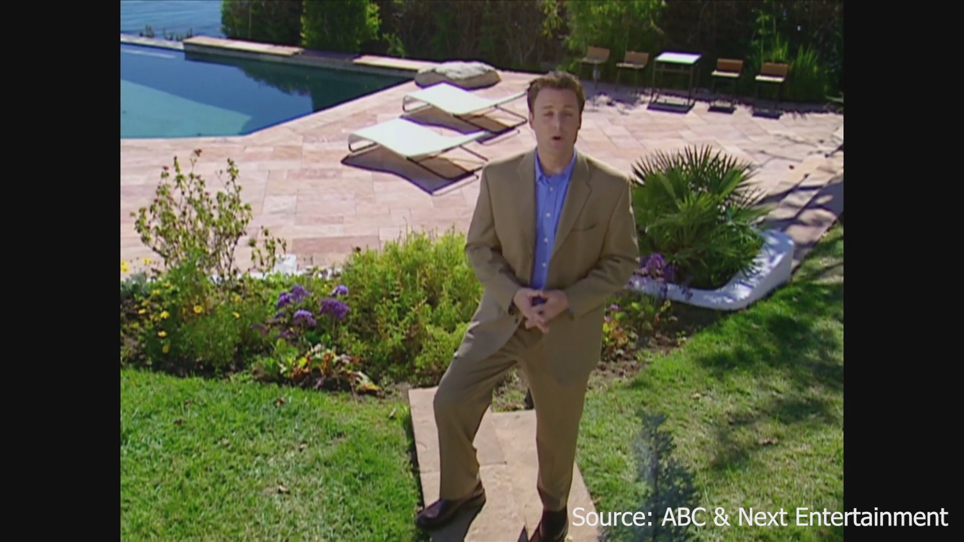 Host Chris Harrison walks through a lush, oceanfront estate during a production segment for The Bachelor.