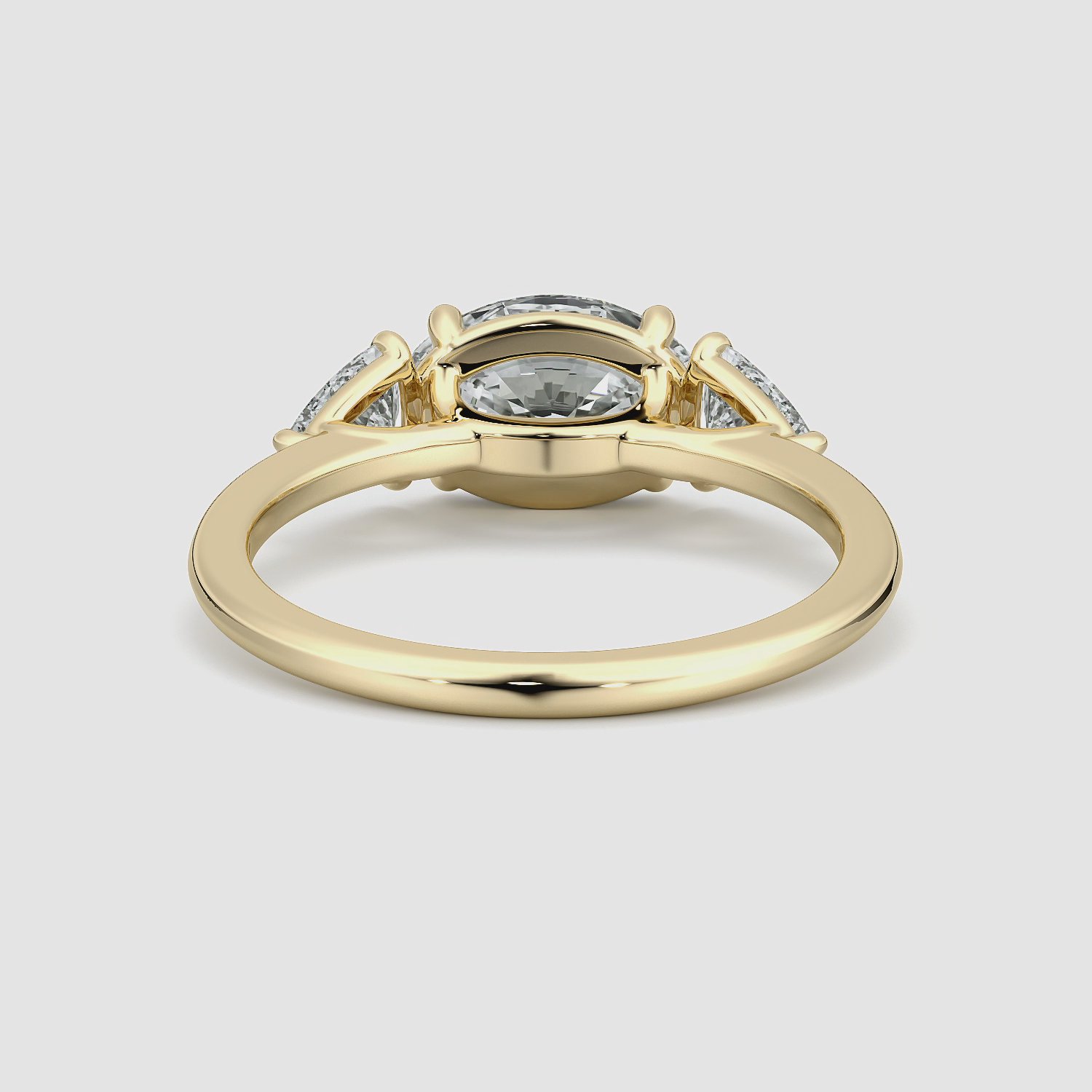 The Three Stone | Oval | 18k | Yellow Gold | bandAccent: Plain | diamondOrientation: horizontal | sideStoneCarat: 0.25ct | sideStoneShape: Trillion | caratWeight: other