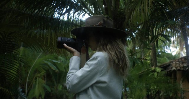 Woman taking photos in the jungle