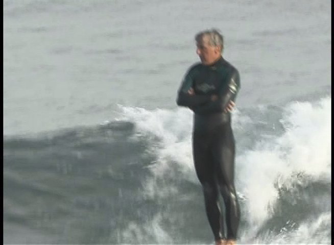 An experienced surfer navigates a wave while wearing a wetsuit before transitioning to an interview segment with a woman.