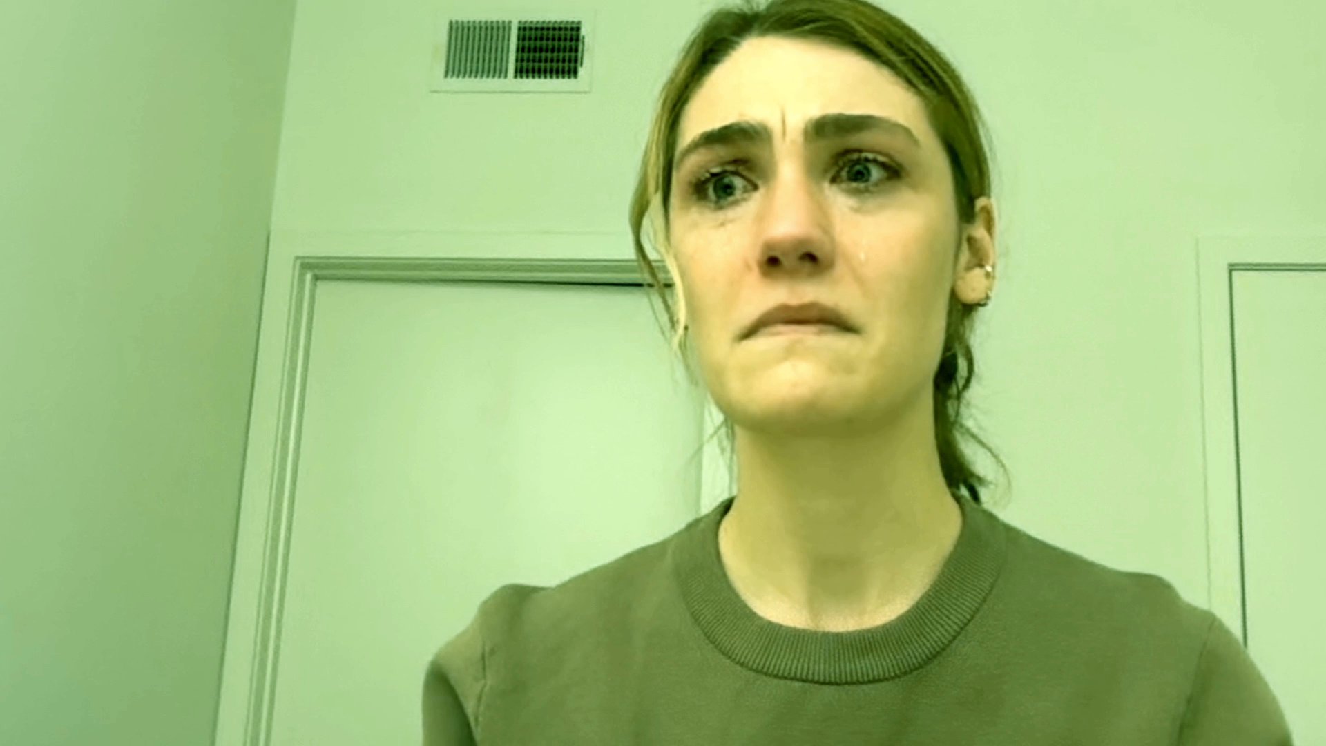 A woman experiences a wave of intense sadness, her facial expressions shifting through visible distress and tears.