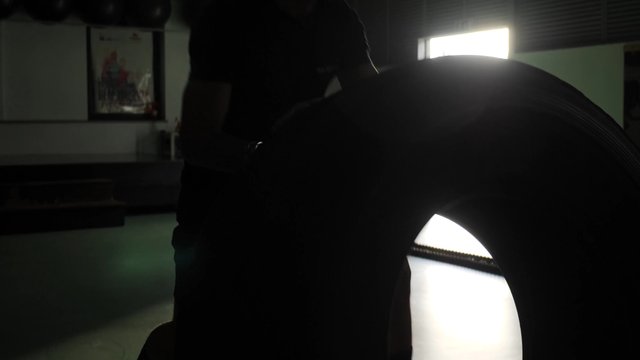 Athlete doing a tire flip exercise