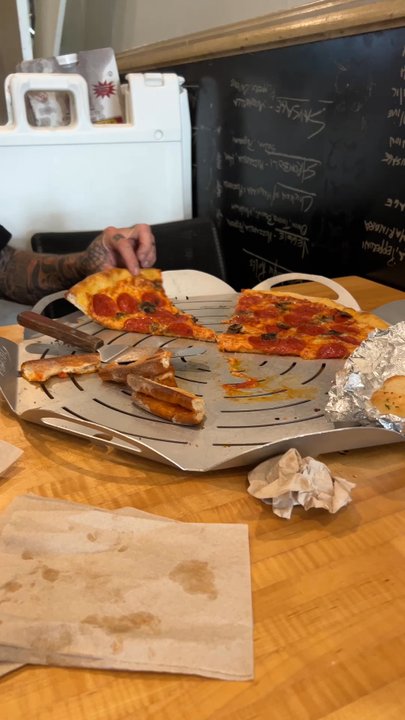 Brooklyn Boyz Pizza - Yummy Benji finishing the pizza at one slice of the time - Pizza Near Me - Oceanside, California