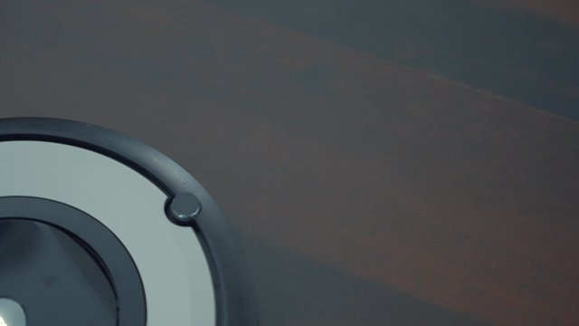 A smart robot cleaner suctioning dust from the floor